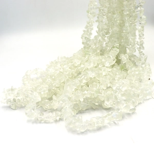 Macro shot of natural irregular transparent crystal chips strand for DIY jewelry making
