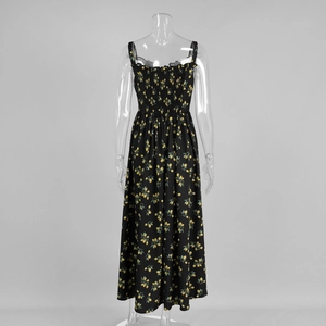 Detail view of the shirred elastic bodice and yellow floral print on the black summer dress