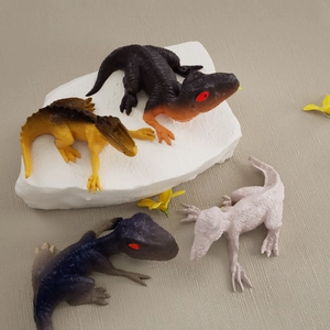 Close-up of four colorful 3D resin dinosaur molds with detailed realistic skin textures