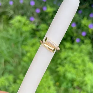 Detail of 18K gold-plated nail-shaped open ring featuring pavé-set cubic zirconia accents