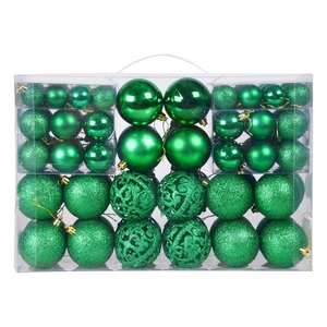 Close-up of green Christmas ball ornaments with matte, glossy, and hollowed-out textures