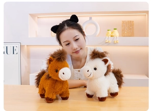 Detail of plush pony set in brown and off-white with fluffy manes and soft texture