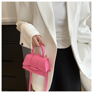 Vibrant bright pink crossbody bag with litchi texture and top handle for women