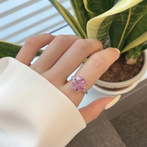 Close-up of a s925 silver ring featuring a large pink zircon in a three-stone setting