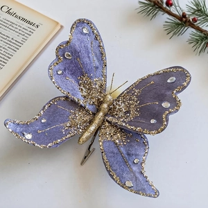 Detail view of purple velvet butterfly clip with gold glitter and rhinestones for Christmas