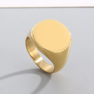 Close-up of polished gold signet ring with flat round surface for custom engraving