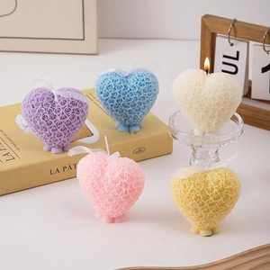Detailed close-up of heart-shaped rose scented candles in various pastel macaron colors