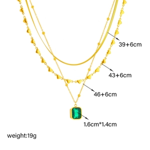 Three-layer gold necklace with snake chain and emerald green rectangle pendant charm