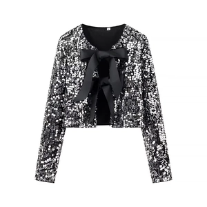 Sparkly sequin cropped jacket featuring a large black bow and long sleeves in a flat lay view