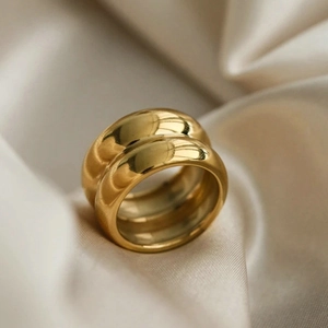 Elegant 18K gold-plated double-layer wide titanium steel ring on soft beige silk background