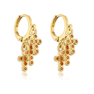 Detail of 18K gold plated hoop earrings with tiered orange zircon pendants on white background