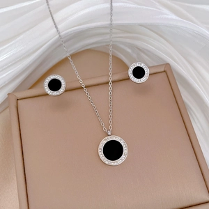 Detailed view of silver necklace and earrings set with black agate and rhinestones