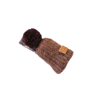 Cute brown plush hat-shaped hair clip with yarn texture and mini pompom on white background