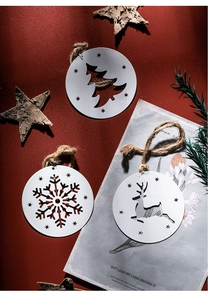 Detailed view of white metal snowflake, deer and tree ornaments with rustic hemp ropes