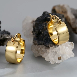 Polished 18K gold plated brass thick hoop earrings on a natural stone background