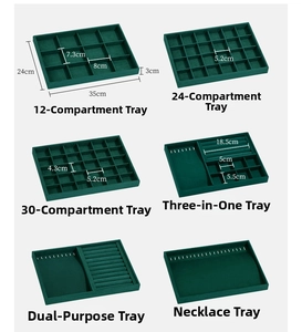Macro view of six various emerald velvet jewelry trays showing detailed compartments