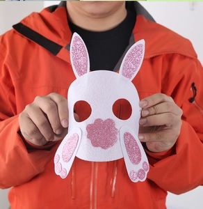 Detailed view of a white felt Easter bunny mask with pink glitter ears for kids parties