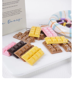 Macro detail of assorted resin chocolate charms with hanging loops for DIY crafts