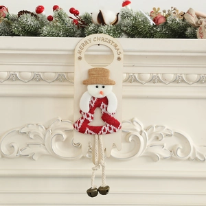 Christmas snowman door hanger with Merry Christmas lettering and copper bells on fireplace