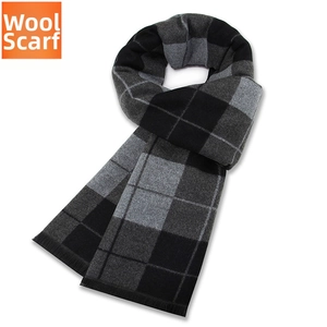 Detailed texture of thick black and grey plaid wool scarf with delicate short fringes