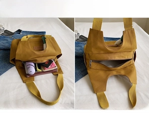 Detail view of ginger yellow canvas tote bag showing back zipper pocket and storage capacity