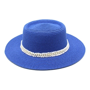 Royal blue boater straw hat with white lace trim and pearl accents for women