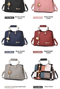 Detail of lychee pattern leather handbag with metallic handles and pearl charm decoration