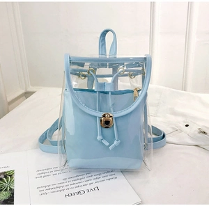 Detail of clear PVC mini backpack with light blue inner pouch and metal turn-lock closure
