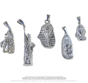 Macro shot of silver stainless steel hip-hop pendants with Pharaoh and skull designs