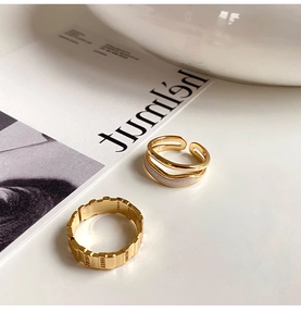 Detailed view of gold textured band and double-layered minimalist open ring set