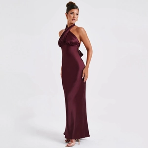 Detail of elegant backless satin maxi dress in burgundy with cross halter neckline