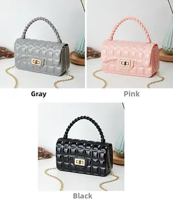 Detailed macro view of quilted PVC jelly bags in grey, pink, and black with chain straps