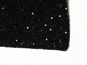 Detailed macro view showing the dense black sequins and fine stitching on the fabric