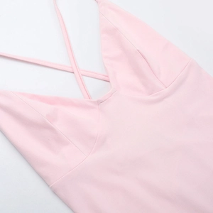 Close-up of pink deep V-neckline with delicate crisscross spaghetti straps detail