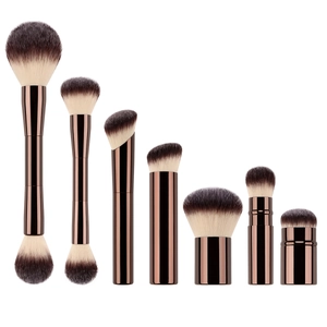 Detailed set of 7 professional makeup brushes with dual-tone bristles and bronze handles