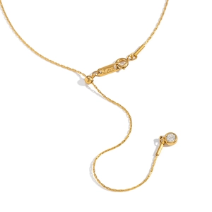 Detailed view of gold stainless steel necklace clasp and adjustable tail chain with charm