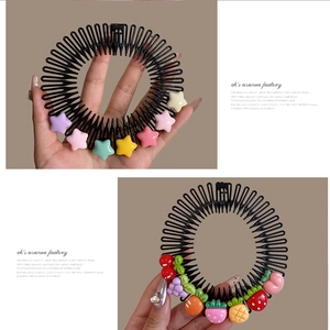 Close-up of flexible black hair side combs with colorful resin stars and fruit ornaments