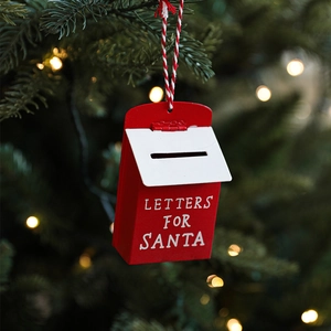 Festive red and white metal Santa mailbox hanging ornament on a Christmas tree branch