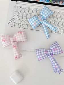 Charmants pendentifs de sac à nœud papillon à carreaux colorés sur un ordinateur