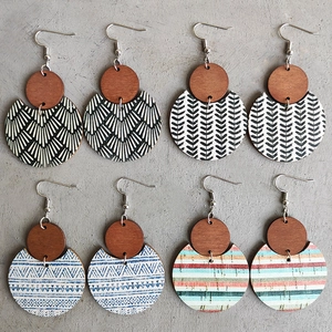 Detailed view of four pairs of bohemian wooden earrings with mixed geometric patterns