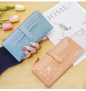 Detail of stone-patterned long wallets in blue and pink with multiple card slots