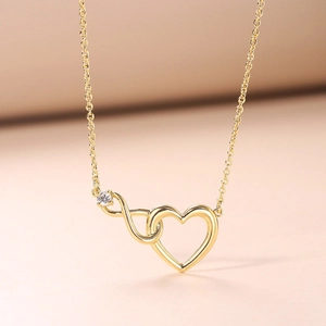 Minimalist gold infinity heart necklace for women featuring a sparkling zirconia pendant