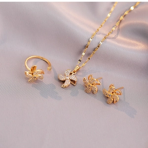 Detailed set of gold sunflower rotating jewelry with necklace, ring and earrings