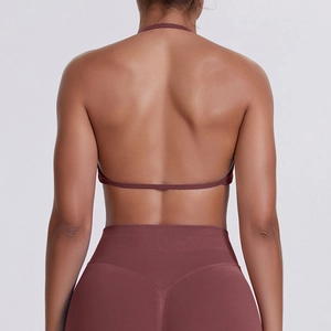 Detailed back view of high-stretch burgundy halter sports bra and V-shaped yoga leggings