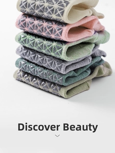Detail of stacked cotton yoga socks featuring anti-slip geometric silicone grips