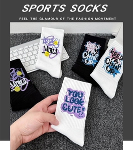 Detail of knit sports socks with colorful graffiti text patterns and ribbed textures