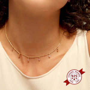 Detail of S925 sterling silver necklace featuring pink marquise stones on model neck