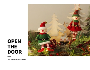 Close-up of cute Christmas elf doll ornaments in a festive wreath with bells