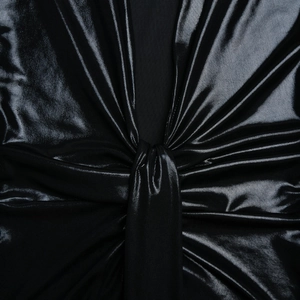Détail du tissu brillant métallique et du nœud élégant sur cette robe noire ajustée