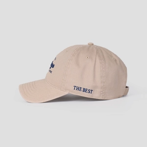Detail of high-quality cotton baseball cap with blue THE BEST letter embroidery on side